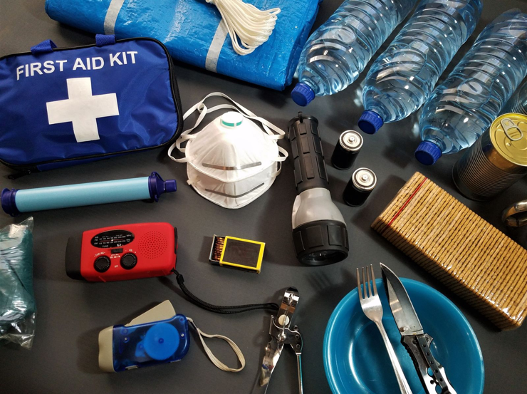 Emergency supplies including water, first aid kit, flashlight and radio.