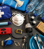 Emergency supplies including water, first aid kit, flashlight and radio.